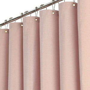 Fabric shower curtain hanging from a rail with metal eyelets and rings