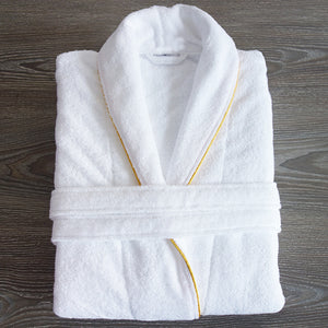 White cotton terry bathrobe folded flat with tie belt