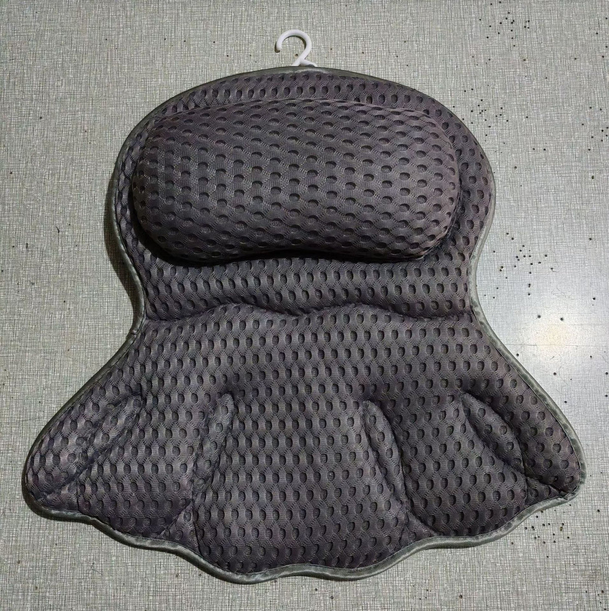 Dark grey mesh bath pillow shown flat