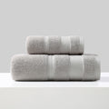 Rolled cotton bath towel and hand towel in light grey