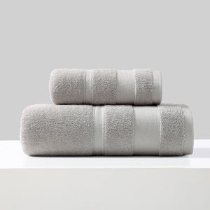 Rolled cotton bath towel and hand towel in light grey