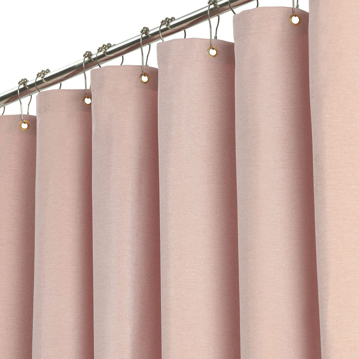 Fabric shower curtain hanging from a rail with metal eyelets and rings