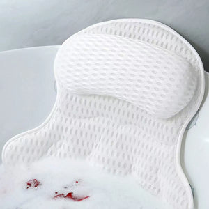 White mesh bath pillow resting against a bathtub