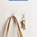 Clear adhesive hooks on a wall holding a bag and keys — No-Drill Adhesive Hooks